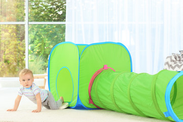 Poster - Cute little boy playing with tunnel at home