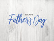 © IrisImages - Happy Father's Day Blue Calligraphy Script Over White Wood Texture Background