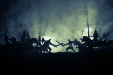 Medieval Battle Scene With Cavalry And Infantry. Silhouettes Of Figures As Separate Objects, Fight Between Warriors On Dark Toned Foggy Background. Night Scene.