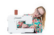 © afxhome - Young girl with glasses sews on a sewing machine, isolated on white background