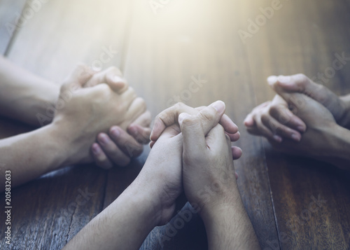 Fotomural Christian bother and sister and praying together around wooden table ,small prayer group in church, christian background with copy space for your text