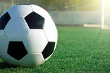 Fototapeta Sport - Football on a green field