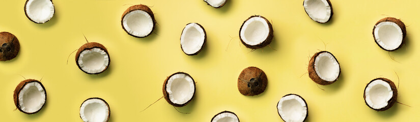 Wall Mural - pattern with ripe coconuts on yellow background. top view. copy space. pop art design, creative summ