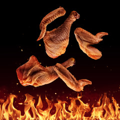 Wall Mural - Flying raw chicken pieces above grill flames