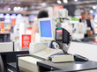 © Joshhh - Cash desk terminal  with cashiers and customers on blurry background