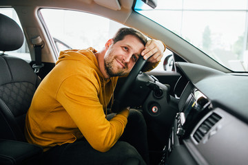 man sits in his lovely car.