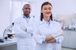 © zinkevych - Feeling great. Alert successful researchers wearing uniforms and standing in the lab