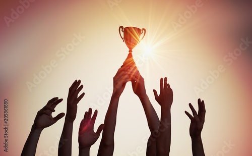 Fotomural Winning team is holding trophy in hands