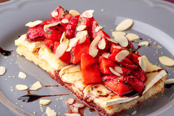 Bruschetta with brie cheese, strawberries and almond flakes