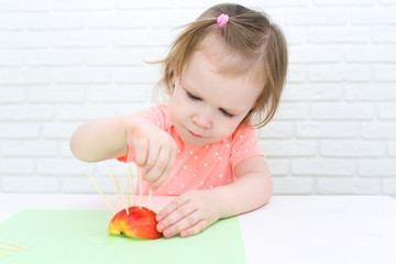 2 years girl made toothpick spines by apple hedgehog