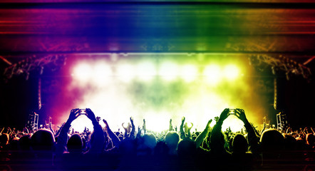 Wall Mural - wide concert arena with lit stage and crowd clapping