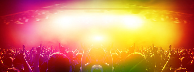 Wall Mural - wide concert arena with lit stage and crowd clapping
