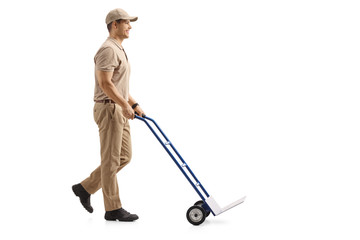 Canvas Print - Delivery man pushing an empty hand truck