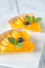 Wall Mural - Slices of tart with peaches and blueberry