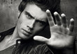© Bakulov - Stop for a moment. Closeup of the face and the palm of a beautiful young man