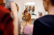 © Parilov - Hairdresser woman conducts training for pupil in salon, weaving braid hair, wedding styling.