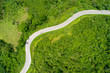 Aerial from drone cars are going through a curves road on mountain. The highway road across a mountain