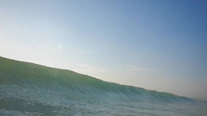 Wall Mural - slow motion shot of sunset surfing wave in indonesia at bali island