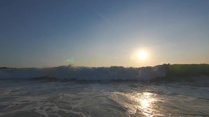 Wall Mural - slow motion shot of sunset surfing wave in indonesia at bali island