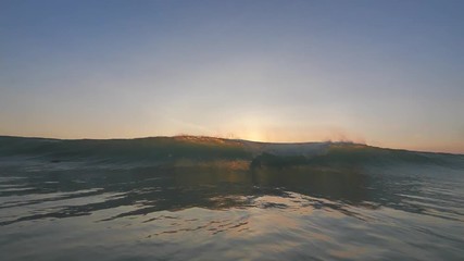 Wall Mural - slow motion shot of sunset surfing wave in indonesia at bali island