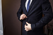 © Yuliia - Businessman wears a jacket,male hands closeup,groom getting ready in the morning before wedding ceremony