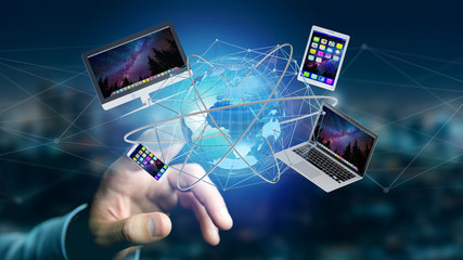 Wall Mural - businessman holding a computer and devices displayed on a futuristic interface with international ne