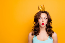Portrait With Copyspace Empty Place Of Funny Stupid Girl Looking At Crown On Head With Eyes Sending Kiss With Pout Lips Isolated On Yellow Background Advertisement Concept