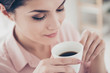 © deagreez - Head close up shot high angle view of attractive pleasant charming woman with long nature eyelashes keeping her eyes closed while smelling aromatic coffee, morning energy, people concept