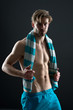 © be free - Hygiene or health and bodycare concept. Fitness athlete with fit torso in shorts. Sportsman with towel on neck after training. Sexy man with muscular chest and belly. Sport and wellness