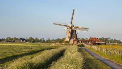 Wall Mural - Wooden historic windmill with cycling track