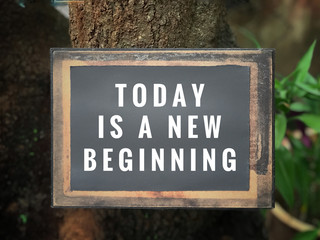 Motivational and inspirational quote - Today is a new beginning. With vintage styled background.