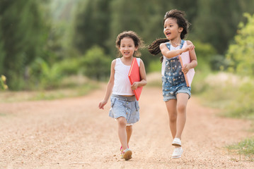 two girl relaxxing with book near the road in country side