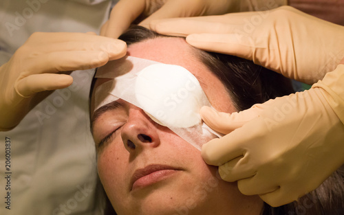 Cuadros en Lienzo Doctor covering eye of patient by medical plaster