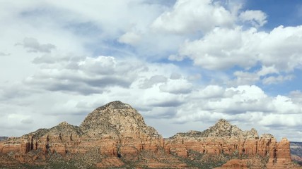 Wall Mural - this looping video footage features clouds floating, in faster time lapse fashion, over the rugged a