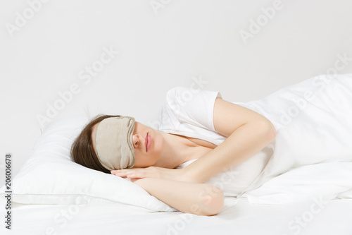 Calm Young Brunette Woman Lying In Bed With Sleep Mask On