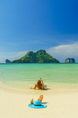 Wall Mural - Woman at the beach in Koh Poda island Thailand with out of office straw hat