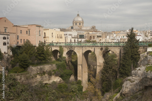 Fotografie, Obraz Bridge over he canyon in small beautiful town in South Italy Massafra, region Pu