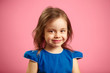 © Ilshat - portrait of beautiful child girl with charming look on isolated blue background.