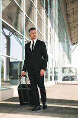 Canvas Print - Charming businessman dressed in suit walking