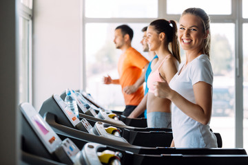 Wall Mural - Picture of people running on treadmill in gym