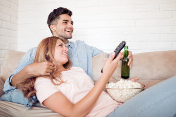 Sticker - Couple in love enjoying drinking beer and watching TV