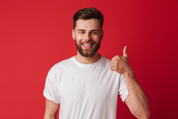 Happy young handsome man showing thumbs up.