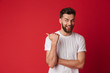 © Drobot Dean - Handsome young emotional man pointing.