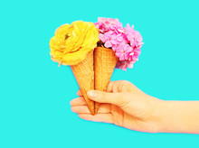  Ice Cream Cone With Flowers Over Blue Background