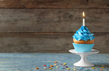 Delicious Birthday Cupcake With Candle On Table