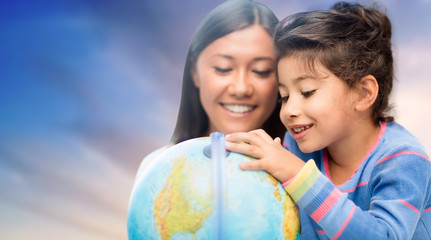 Poster - family, education, travel and people concept - mother and daughter with globe over evening sky background