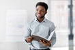 © Syda Productions - business, people and corporate concept - smiling african american businessman with folder at office
