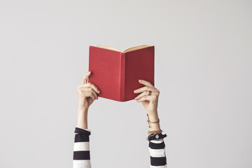 the hand holding book on isolated background