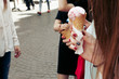 ice cream in hand. Group of women holding chocolate and pink ice-cream in hands close-up, partying and having fun in city street
