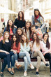© sonyachny - stylish happy women hipsters fashionable dressed smiling and sitting on bench in europe city street, joyful moments friendship concept